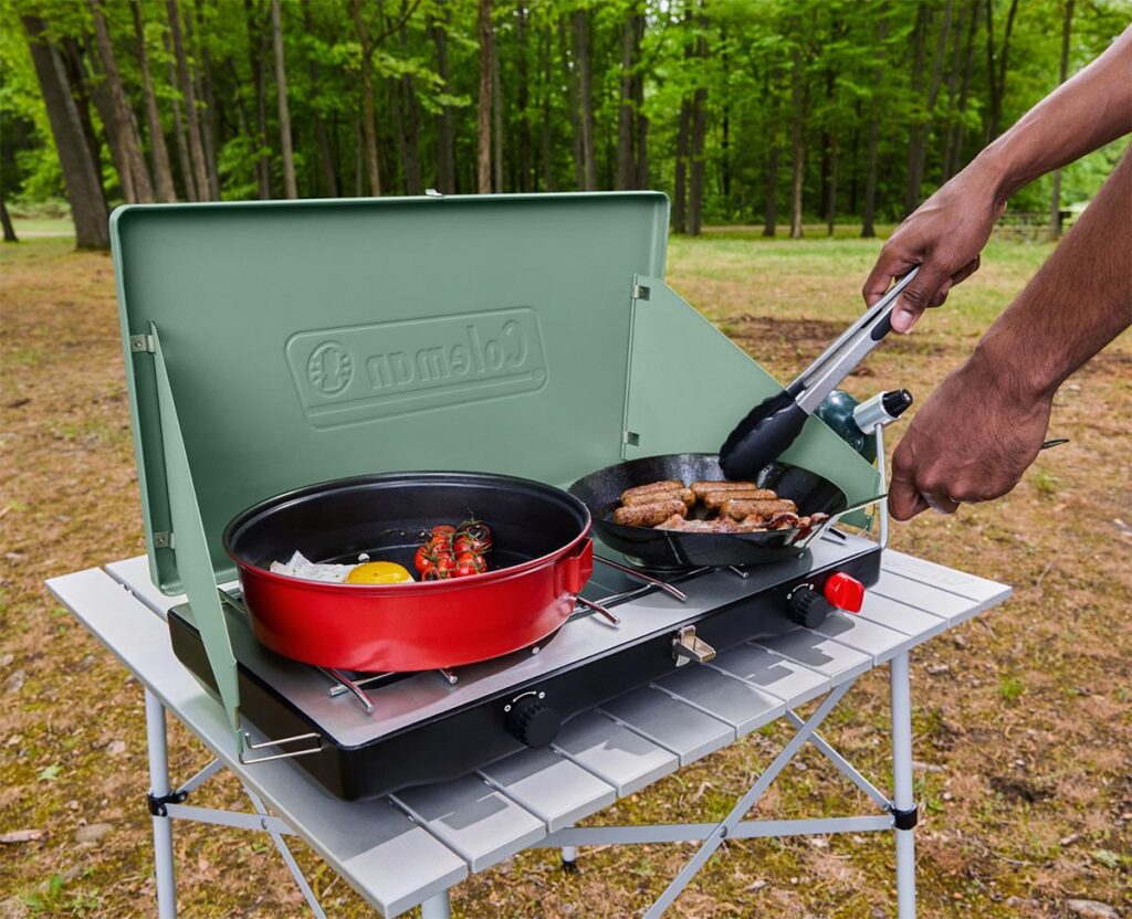 Man cooking with a portable camping stove