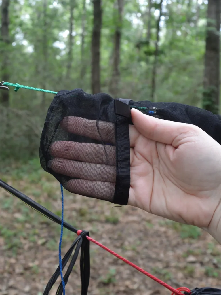 pocket in the end of mesh tarp sleeve with fingers inside it